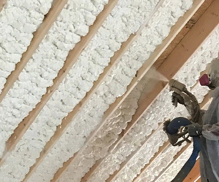 Spray Foam Insulation being applied inbetween the roof rafters